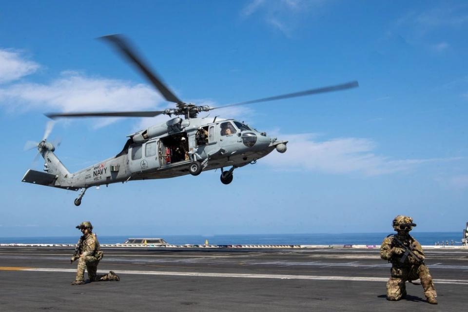 A photo of a helicopter landing on the USS Gerald R. Ford.