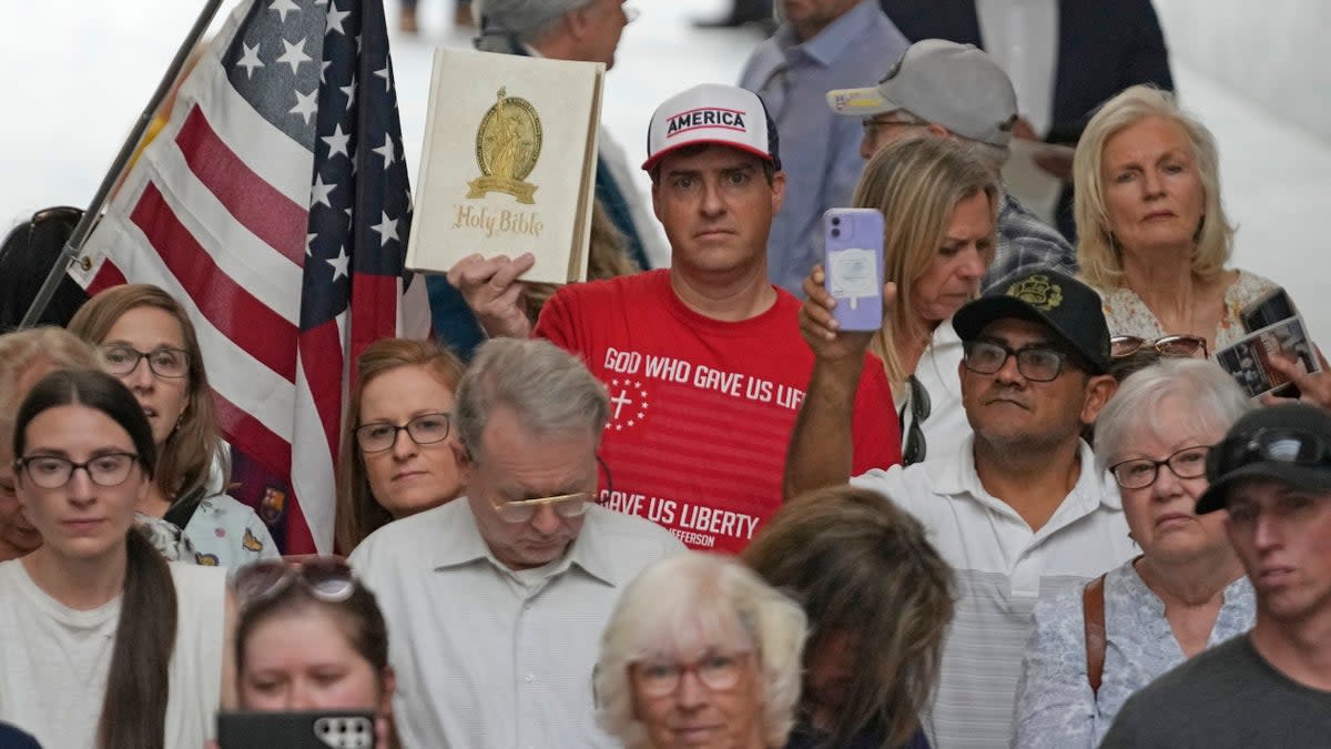 People gather during a rally Wednesday, 7 June 2023, at the Utah State Capitol, in Salt Lake City. Bible-toting parents and Republican lawmakers convened on Utah’s Capitol to protest a suburban school district that announced it had removed the Bible from some schools last week  (AP)