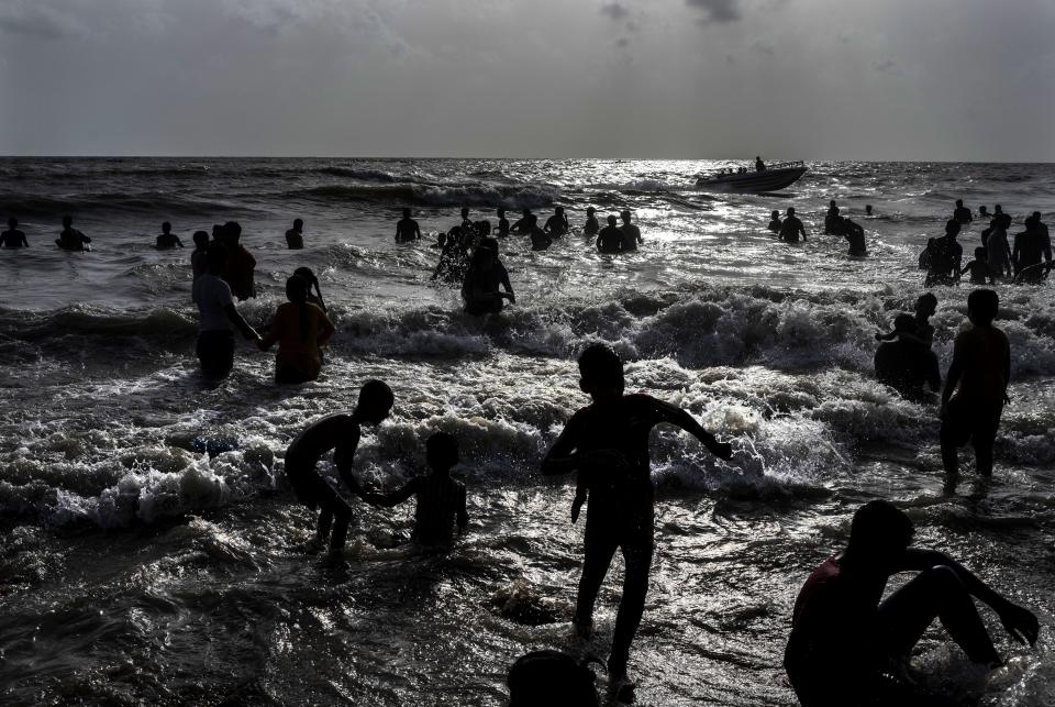 FILE - Children play at a crowded Juhu beach on the Arabian Sea coast on a hot and humid day in Mumbai, India, May 22, 2022. Demographers are unsure exactly when India will take the title as the most populous nation in the world because they're relying on estimates to make their best guess. (AP Photo/Rafiq Maqbool, File)