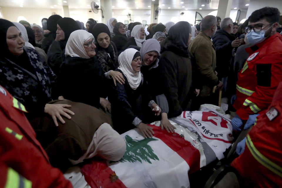 People mourn over the coffins of paramedics who were killed in an Israeli airstrike, during a funeral procession in Hebbariye village, south Lebanon, Wednesday, March 27, 2024. The Israeli airstrike on a paramedic center linked to a Lebanese Sunni Muslim group killed several of its members. The strike was one of the deadliest single attacks since violence erupted along the Lebanon-Israel border more than five months ago. (AP Photo/Mohammed Zaatari)