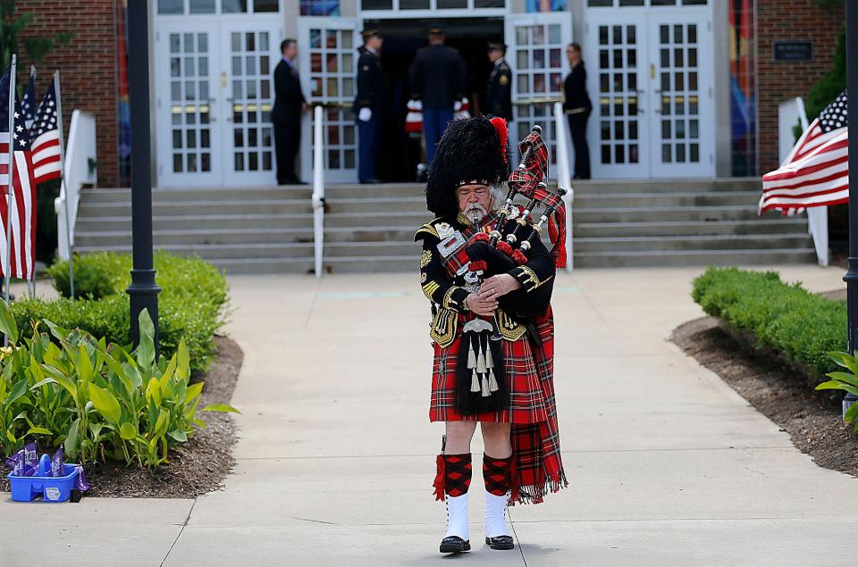 Bagpiper Jeff Linn leads the casket recessional for Pfc. Sanford Keith Bowen, who was killed in action in France during WWII. Bowen's remains were recently identified and returned home. A funeral service was held Friday at Ashland University's Miller Chapel.
