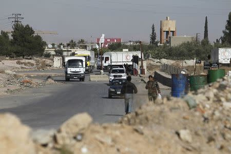 A Red Crescent aid convoy enters Wafideen Camp, which is controlled by Syrian government forces, to deliver aid into the rebel held besieged city of Douma, Damascus suburbs, Syria February 13, 2016. REUTERS/Omar Sanadiki