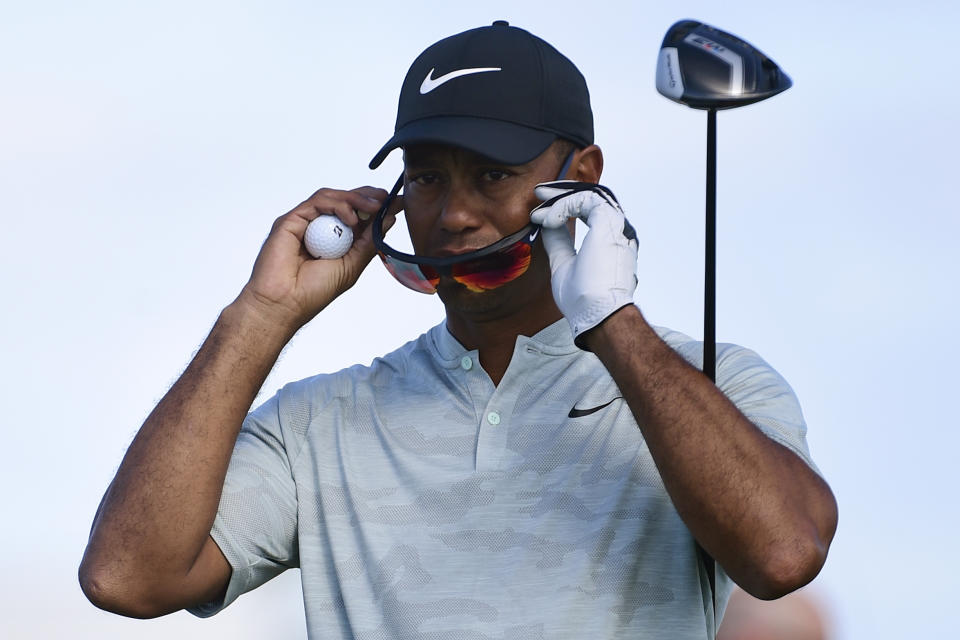 Tiger Woods adjusts his sunglasses before hitting from the seventh hole during the first round of the Hero World Challenge at the Albany Golf Club in Nassau, Bahamas, Thursday, Nov. 29, 2018. Woods now is No. 13 in the world as he hosts this holiday tournament for the 20th time. (AP Photo/Dante Carrer)