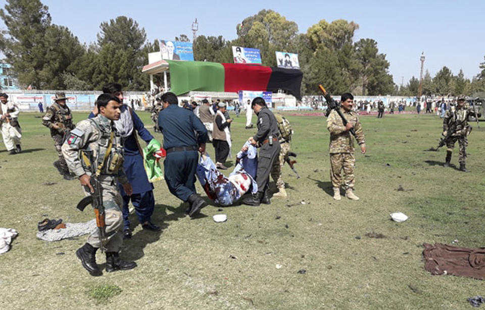 Wounded men are tended to following multiple explosions in Lashkar Gah city of Helmand province, southern Afghanistan, Saturday, Mar. 23, 2019. An Afghan official says that at least three have been killed in twin bomb explosions occurred during the Farmer’s Day ceremony in southern Helmand province. (AP Photo/Abdul Khaliq)