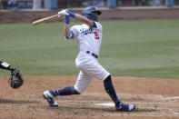 Los Angeles Dodgers' Cody Bellinger follows through on a solo home run against the Colorado Rockies during the sixth inning of a baseball game in Los Angeles, Sunday, Aug. 23, 2020. (AP Photo/Alex Gallardo)