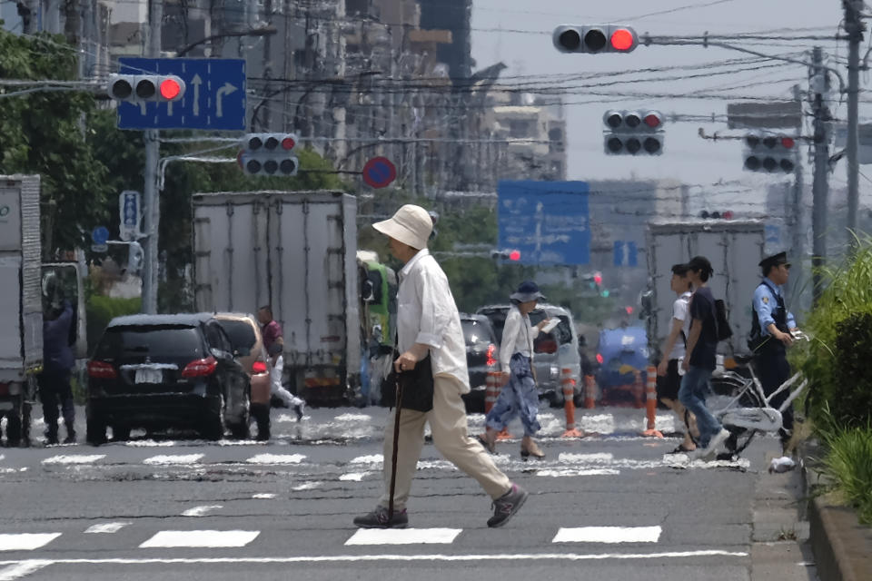 Heat haze distorts the background as pedestrians walk past during a heatwave in Tokyo on July 31, 2019. (Photo by Kazuhiro NOGI / AFP)        (Photo credit should read KAZUHIRO NOGI/AFP/Getty Images)