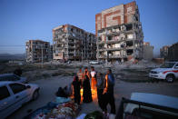 <p>In this photo provided by the Iranian Students News Agency, ISNA, survivors of the earthquake warm themselves in front of destroyed buildings at the city of Sarpol-e-Zahab in western Iran, Nov. 13, 2017.(Photo: Farzad Menati/Tasnim News Agency via AP) </p>