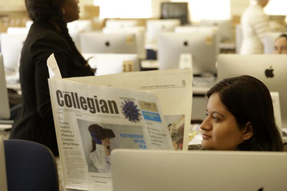 Student journalist Dulce Galvez reads a copy of the Collegian campus newspaper at Los Angeles City College