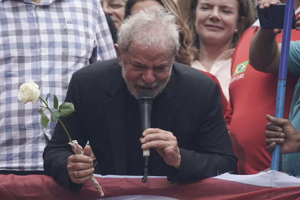 Former Brazilian President Luiz Inacio Lula da Silva thanks a supporter for the rose he was handed during a rally at the Metal Workers Union headquarters, in Sao Bernardo do Campo, Brazil, Saturday, Nov. 9, 2019. Da Silva addressed thousands of jubilant supporters a day after being released from prison. "During 580 days, I prepared myself spiritually, prepared myself to not have hatred, to not have thirst for revenge," the former president said. (AP Photo/Leo Correa)