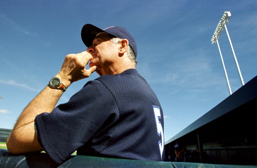 Angels coach Sam Suplizio watches from the dugout as the Angels take on the Oakland Athletics in 1998.