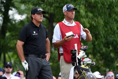 FILE PHOTO - Jun 17, 2016; Oakmont, PA, USA; Phil Mickelson with caddie Jim MacKay on the 13th tee during the continuation of the first round of the U.S. Open golf tournament at Oakmont Country Club. Mandatory Credit: Kyle Terada-USA TODAY Sports