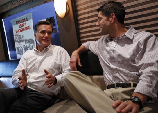 Mitt Romney (L) speaks with vice Paul Ryan on their campaign bus before a campaign event in Waukesha, Wisconsin August 12, 2012.