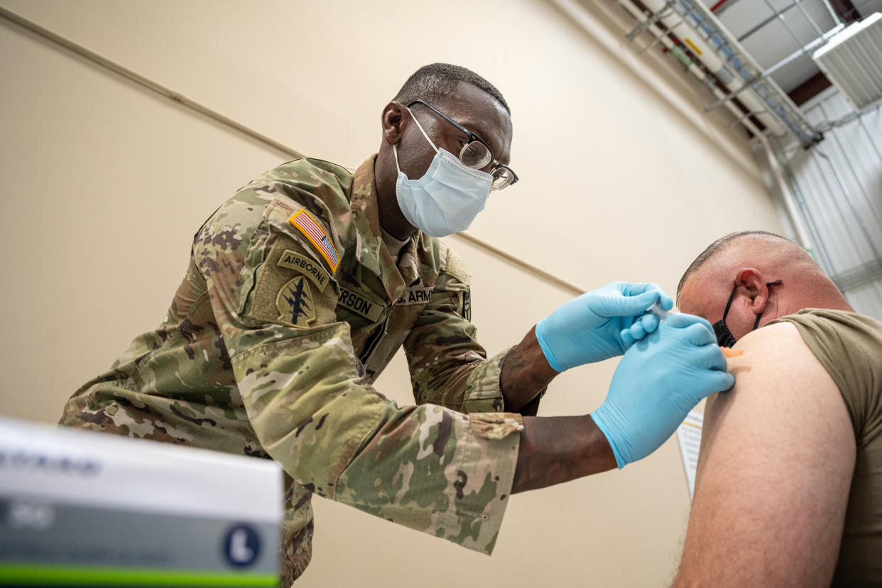 Preventative Medicine Services NCOIC Sergeant First Class Demetrius Roberson administers a COVID-19 vaccine to a soldier on September 9, 2021 in Fort Knox, Kentucky. (Jon Cherry/Getty Images)