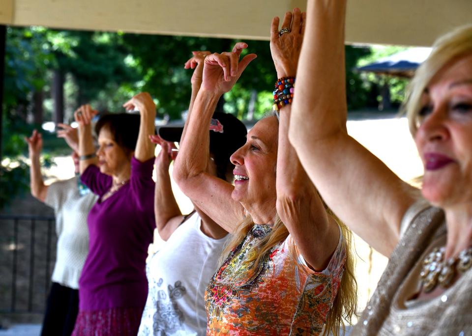 SHREWSBURY - Members of Silver Moon Gypsies practice their "gypsy fusion" style of dancing under a pavillion at Dean Park on Tuesday.