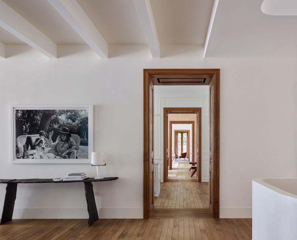 A classic enfilade architectural element affords views from the music room, living room, dining room, kitchen, and stairwell while maintaining privacy. The Belgian oak flooring is from Exquisite Surfaces, and the plaster finishes are by Chicago Ornamental Plaster.