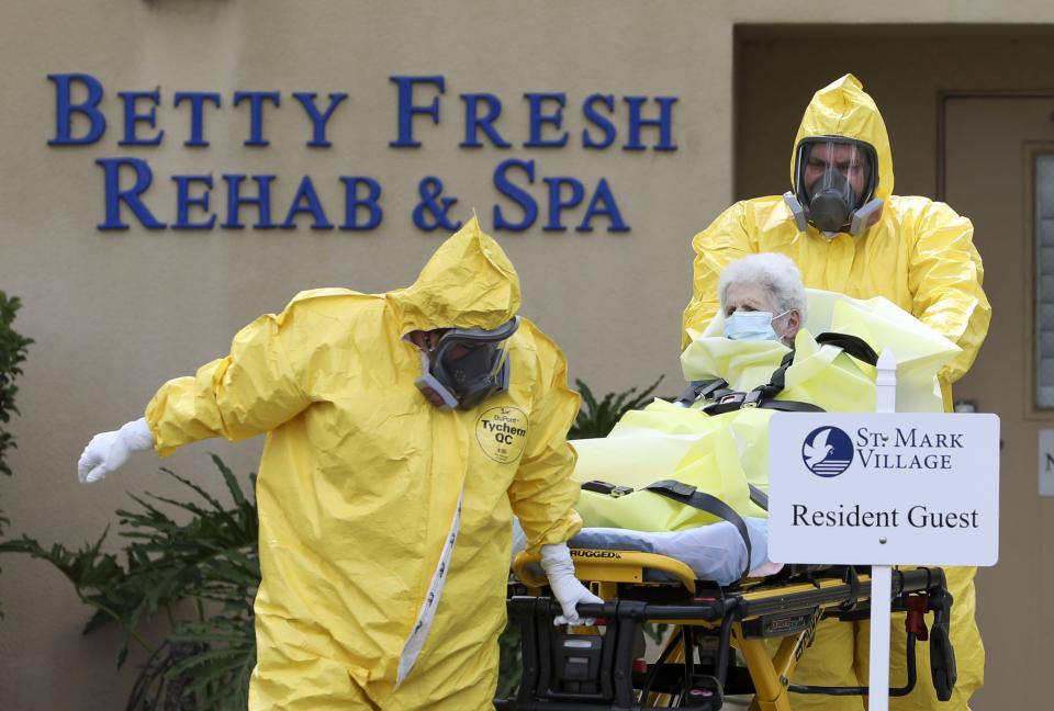 A resident is transported from St. Mark Village Monday, April 20, 2020 in Palm Harbor. Several residents were transported from St. Mark Village Monday to local hospitals. It is presumed the residents had tested positive for COVID-19 or coronavirus. (Chris Urso/Tampa Bay Times via AP)