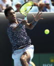 Canada's Felix Auger-Aliassime makes a forehand return to Latvia's Ernests Gulbis during their first round singles match at the Australian Open tennis championship in Melbourne, Australia, Tuesday, Jan. 21, 2020. (AP Photo/Dita Alangkara)