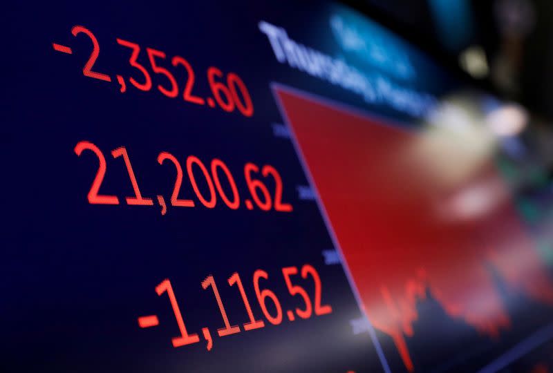 FILE PHOTO: A price screen display is seen above the floor of the New York Stock Exchange (NYSE) after the close of trading in New York