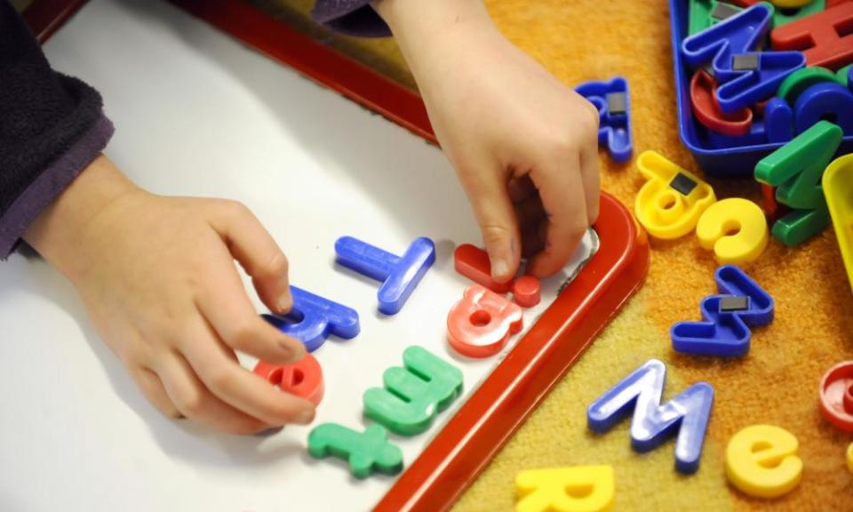 A child playing with letters of the alphabet