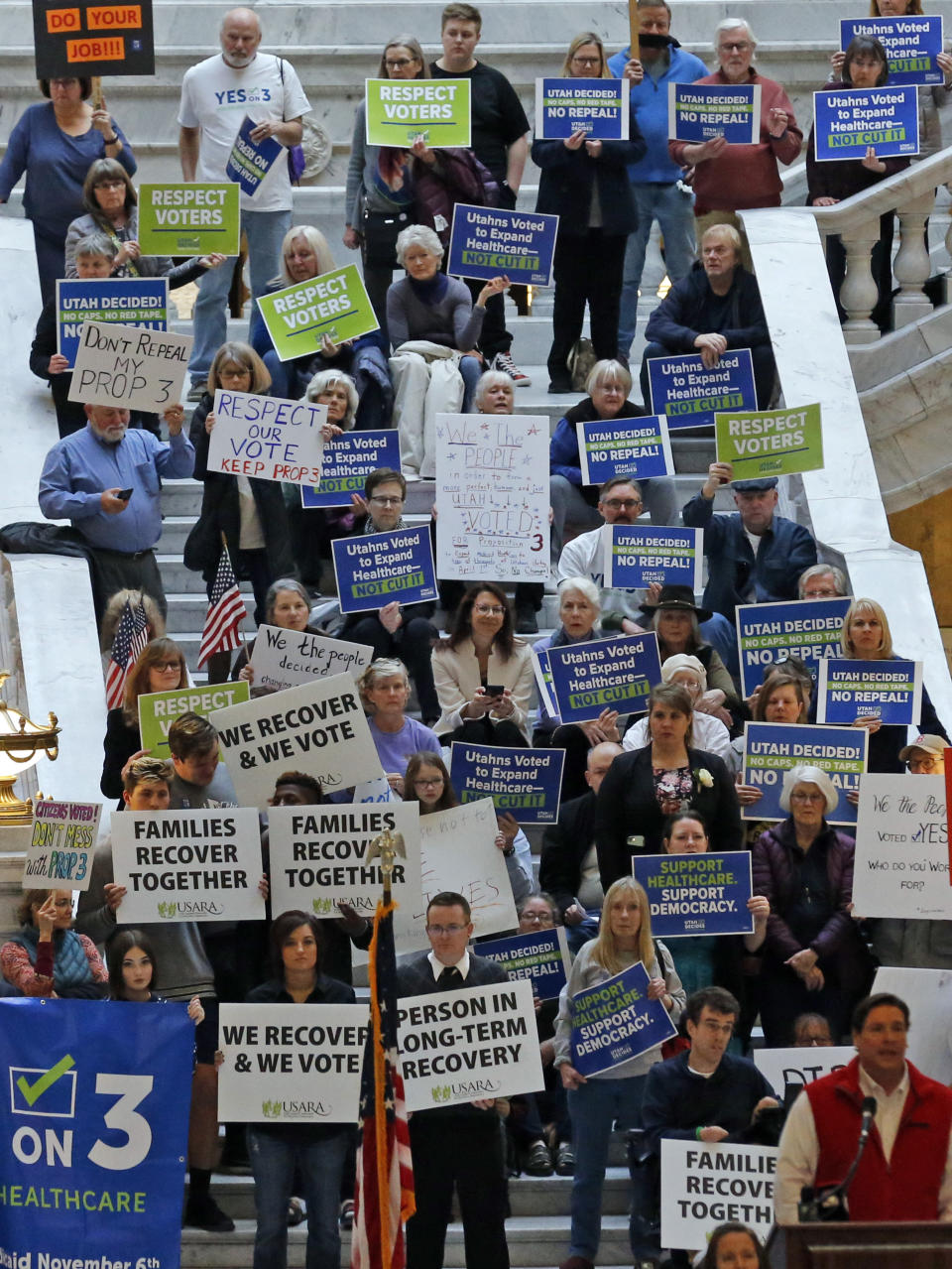 FILE - In this Jan. 28, 2019 file photo, supporters of a voter-approved measure to fully expand Medicaid, gather with others during a rally at the Utah State Capitol urging lawmakers not to change the law. Despite those pleas, Utah lawmakers earlier this year scaled back the Medicaid expansion approved by voters in November. President Donald Trump's administration has rejected Utah's planned request for enhanced federal funding for partial expansion of its Medicaid program, state officials said Saturday, July 27, 2019.(AP Photo/Rick Bowmer, File)