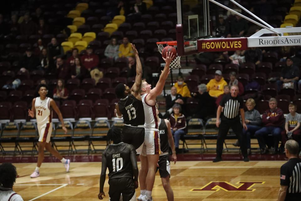 Northern State's Trey Longstreet goes up for a layup while Southwest Minnesota State's Kenny Byers goes for a block attempt.