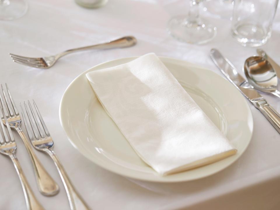 White plate and cutlery on a table