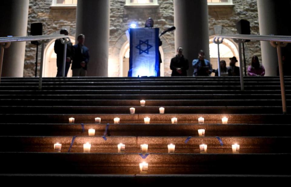 Candles glow in the shape of the Star of David as Penn State students and community members gathered outside of Old Main to pray and show support for Israel on Tuesday, Oct. 10, 2023.