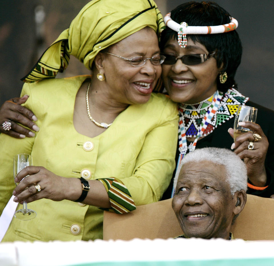 <p>Former South African President Nelson Mandela with his former wife Winnie Mandela, right, and current wife Graca Machel at the ANC Madiba 90th Birthday Celebrations on Aug. 2, 2008, in Tshwane, South Africa. (Photo: Michelly Rall/WireImage via Getty Images) </p>