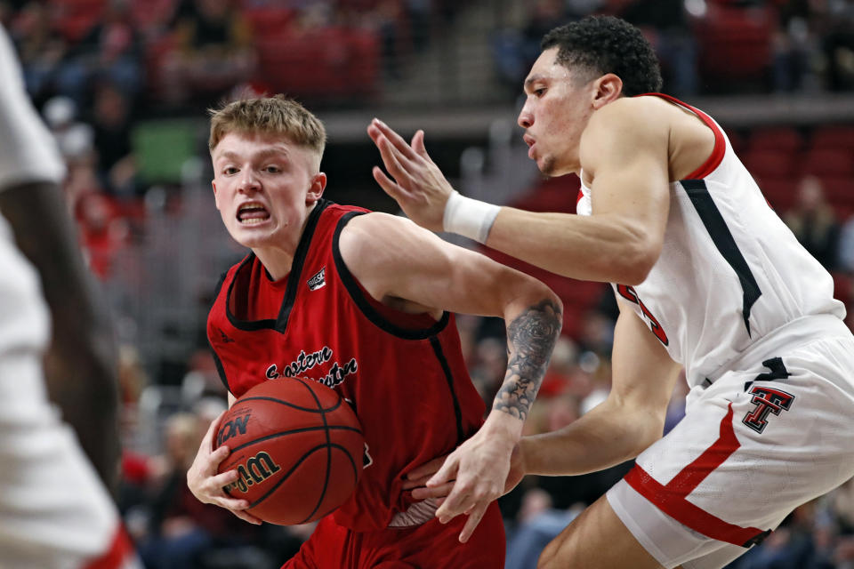 Eastern Washington's Mason Landdeck (24) dribbles the ball around Texas Tech's Clarence Nadolny (3) during the first half of an NCAA college basketball game on Wednesday, Dec. 22, 2021, in Lubbock, Texas. (AP Photo/Brad Tollefson)