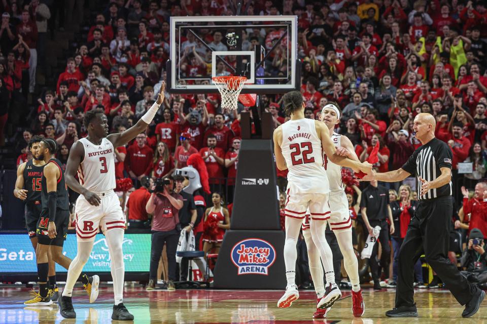 Rutgers Scarlet Knights guard Paul Mulcahy (4) celebrates after basket with guard Caleb McConnell (22) against the Maryland Terrapins at Jersey Mike's Arena.