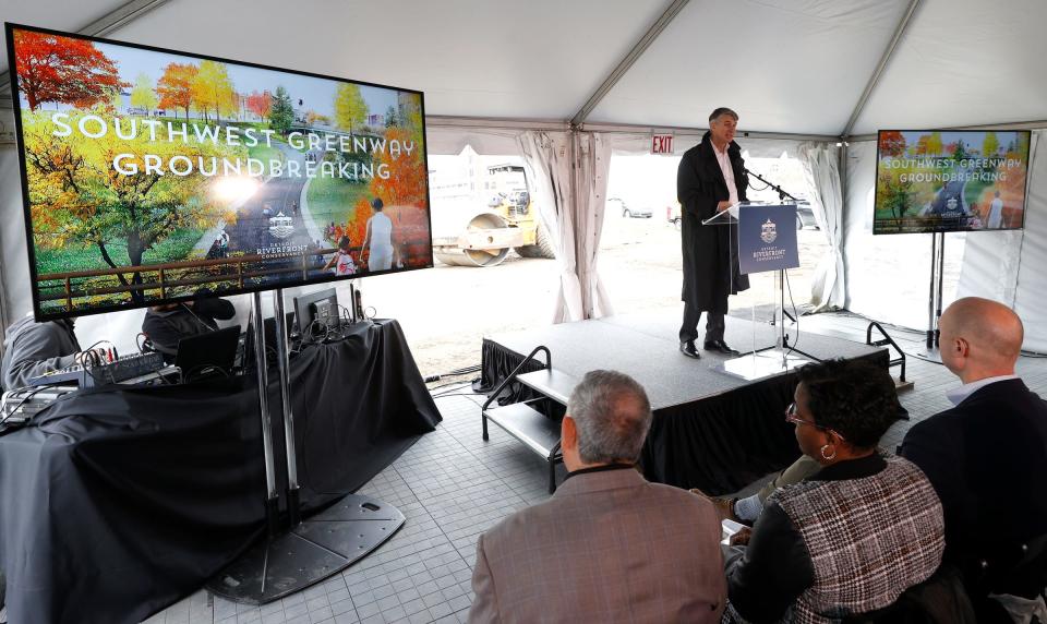 David Egner, president and CEO of the Ralph C. Wilson, Jr. Foundation, talks to people before the groundbreaking on Wednesday, April 6, 2022, at the Southwest Greenway as part of the Detroit Riverfront Conservancy expansion of the West Riverfront. The new project will go from Bagley to Jefferson Avenue and connect the Detroit Riverfront and future Ralph C. Wilson Jr. Centennial Park with the Michigan Central mobility innovation district.