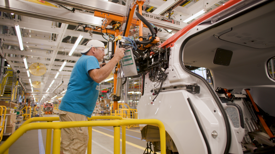 A worker assembles a Cruise Origin self-driving vehicle at Factory Zero in Detroit and Hamtramck.