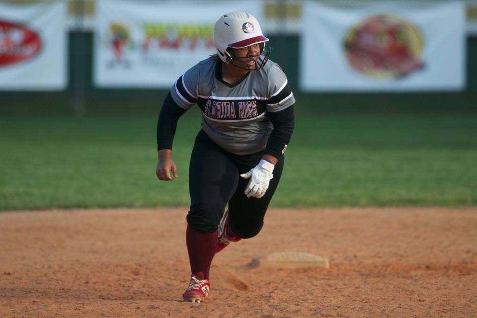 Florida High junior infielder Jaysoni Beachum runs to third base in a game against Lincoln on April 11, 2022, at Lincoln High School. The Trojans won, 5-2.