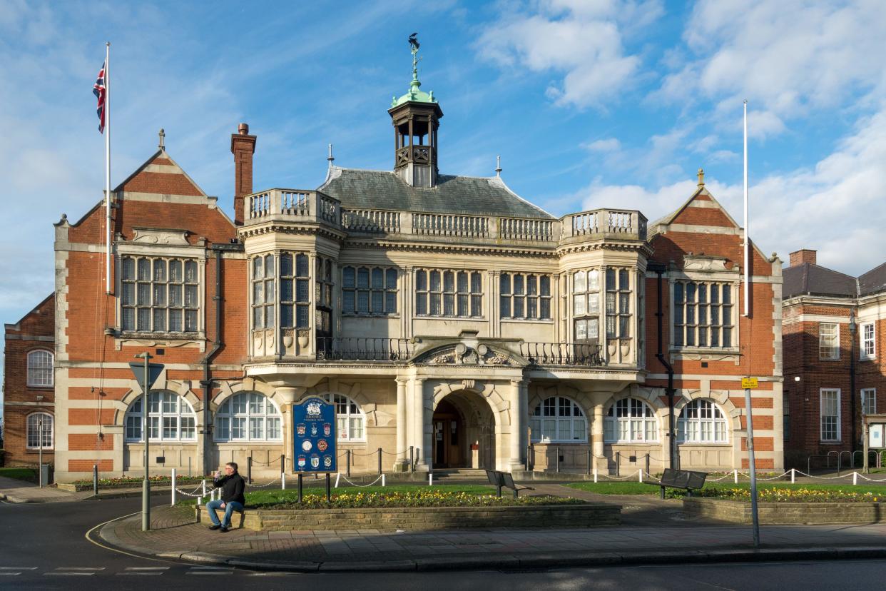 Hendon Town Hall with a man drinking a bottle of water in the foreground.