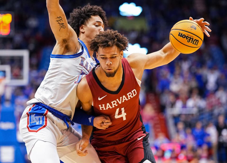 Harvard Crimson forward Chris Ledlum (4) drives against Kansas Jayhawks forward Jalen Wilson (10) during the first half at Allen Fieldhouse.