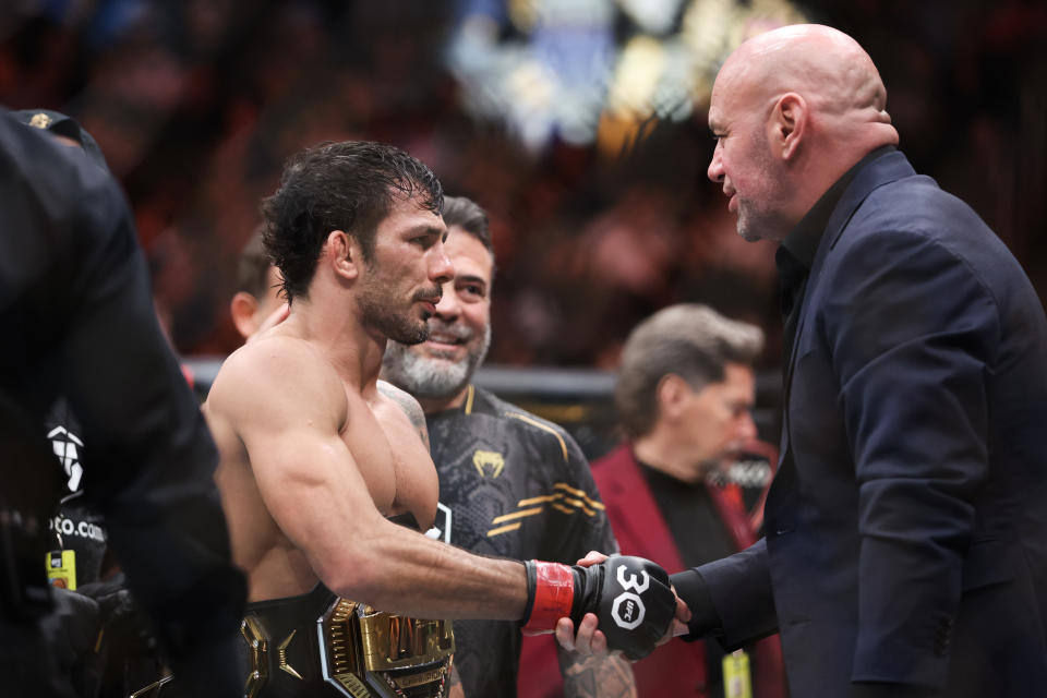 LAS VEGAS, NEVADA - DECEMBER 16: Alexandre Pantoja of Brazil (L) shakes hands with UFC CEO Dana White following the flyweight title fight against Brandon Royval of the United States during the UFC 296: Edwards vs. Covington event at T-Mobile Arena on December 16, 2023 in Las Vegas, Nevada. (Photo by Sean M. Haffey/Getty Images)