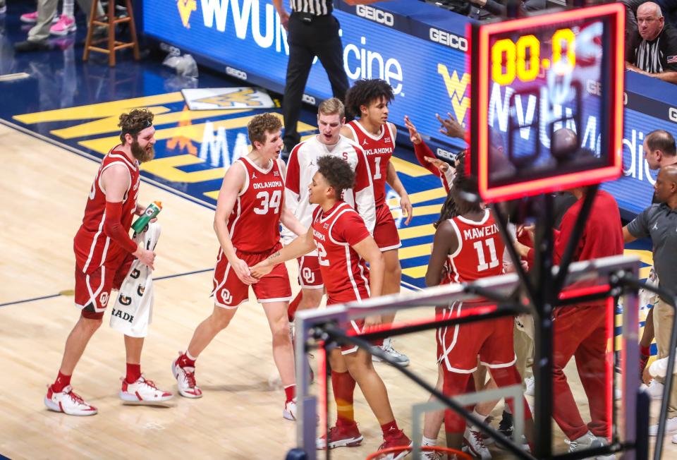 Jan 26, 2022; Morgantown, West Virginia, USA; Oklahoma Sooners forward Jacob Groves (34) celebrates with teammates after a made three pointer at the end of the first half against the West Virginia Mountaineers at WVU Coliseum.