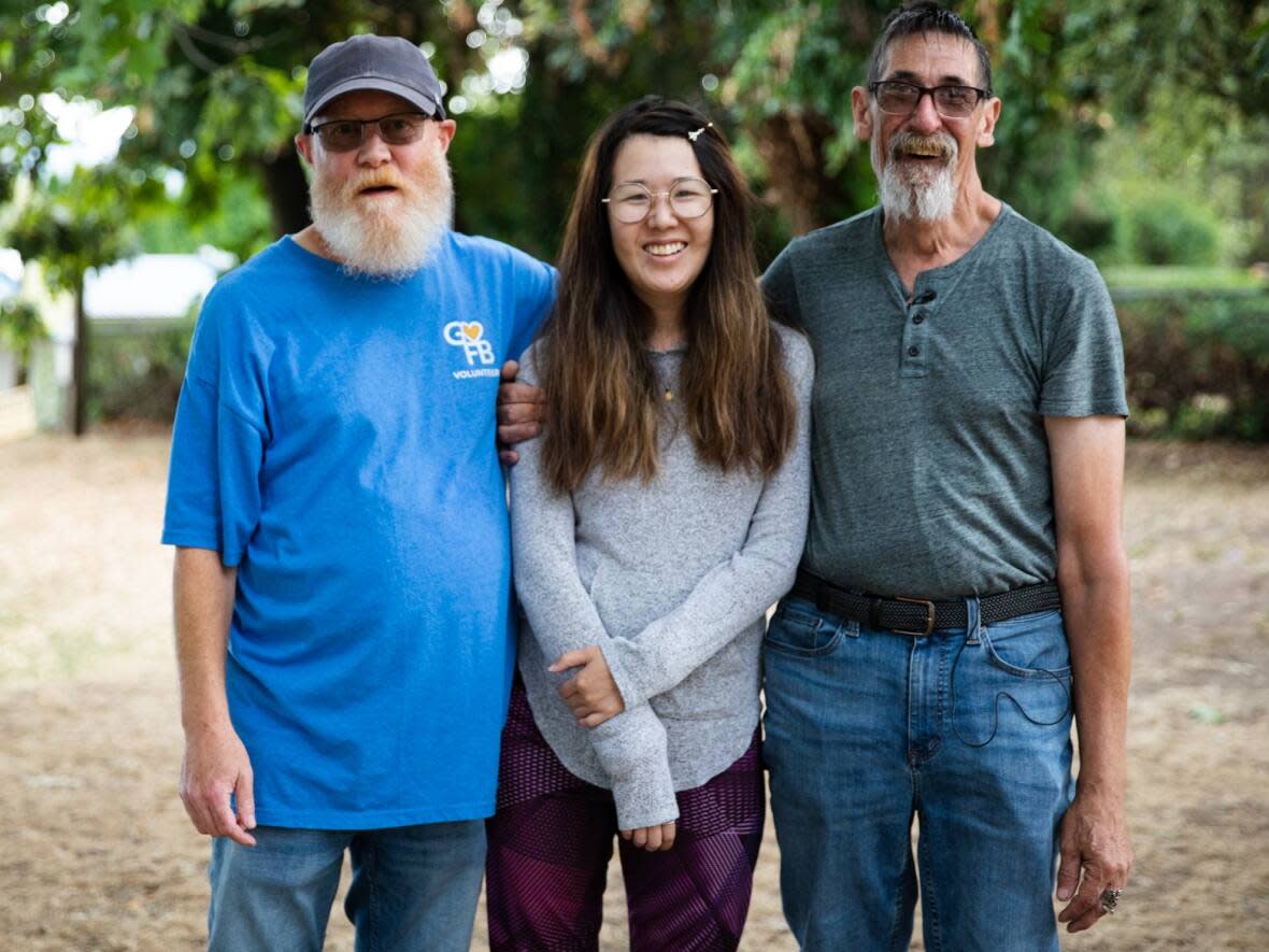 Jeff MacPherson, left, Alison Chow, centre, and Tim Williams all live together at Lina's Place in New Westminster, B.C., an assisted living facility for people with mental illnesses. They say they consider each other to be family, and don't want to be split up when Lina's Place closes in July 2023.  (Justine Boulin/CBC - image credit)