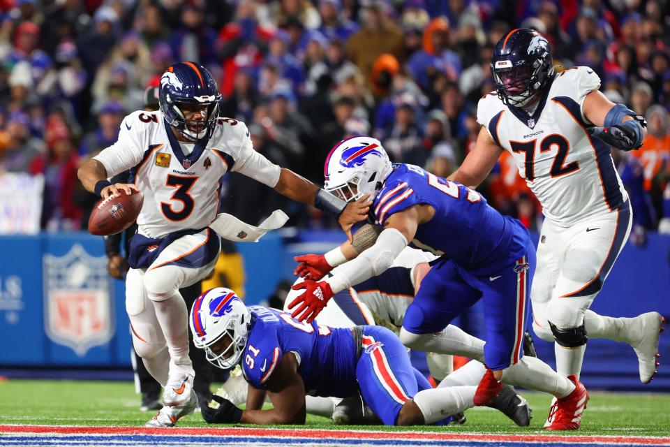 ORCHARD PARK, NEW YORK - NOVEMBER 13: Russell Wilson #3 of the Denver Broncos carries the ball against the Buffalo Bills during the third quarter of the game at Highmark Stadium on November 13, 2023 in Orchard Park, New York. (Photo by Timothy T Ludwig/Getty Images)