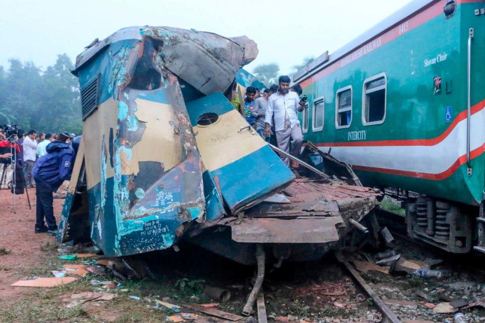 Bystanders look on after a train collided with another train in Brahmanbaria (AFP via Getty Images)