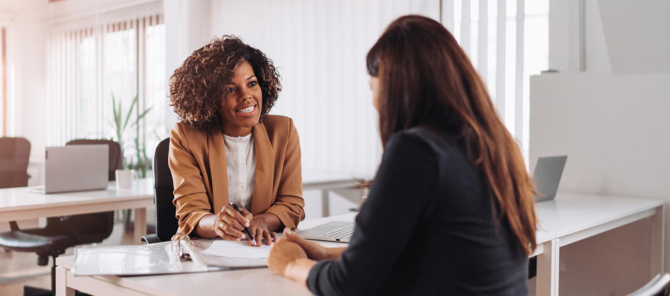 Female financial consultant manager talking with a client at the bank