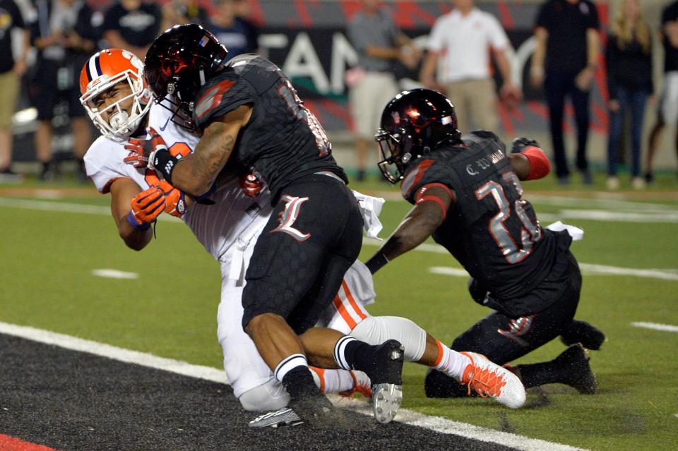 Sep 17, 2015; Louisville, KY, USA; Clemson Tigers tight end Jordan Leggett (16) scores a touchdown while being tackled by Louisville Cardinals cornerback Jaire Alexander (10) during the second half at Papa John's Cardinal Stadium. Clemson defeated Louisville 20-17.  Mandatory Credit: Jamie Rhodes-USA TODAY Sports