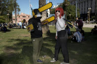 Supporters of Argentina's newly sworn-in President Javier Milei stand outside the government house in Buenos Aires, Argentina, Sunday, Dec. 10, 2023. (AP Photo/Rodrigo Abd)
