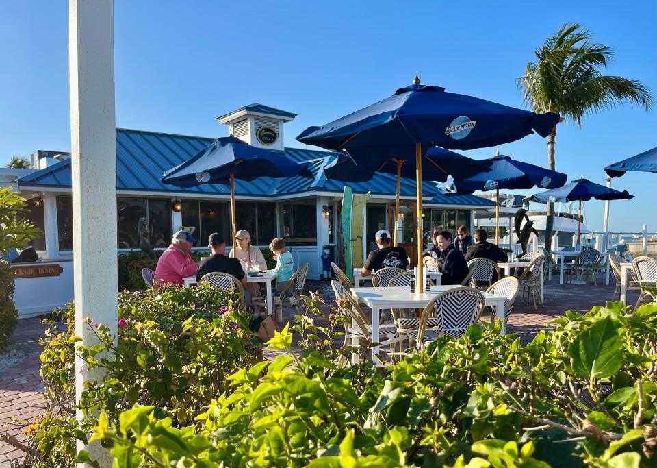 Dine under blue umbrellas on the spacious patio at Gramma Dot's on Sanibel.