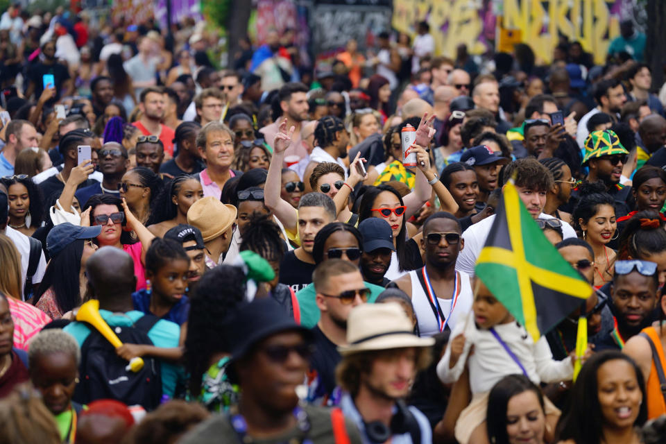 Carnival-goers gather during the Family Day at the Notting Hill Carnival which returned to the streets for the first time in two years, after it was thwarted by the pandemic, in London, Sunday, Aug. 28, 2022. (Victoria Jones/PA via AP)