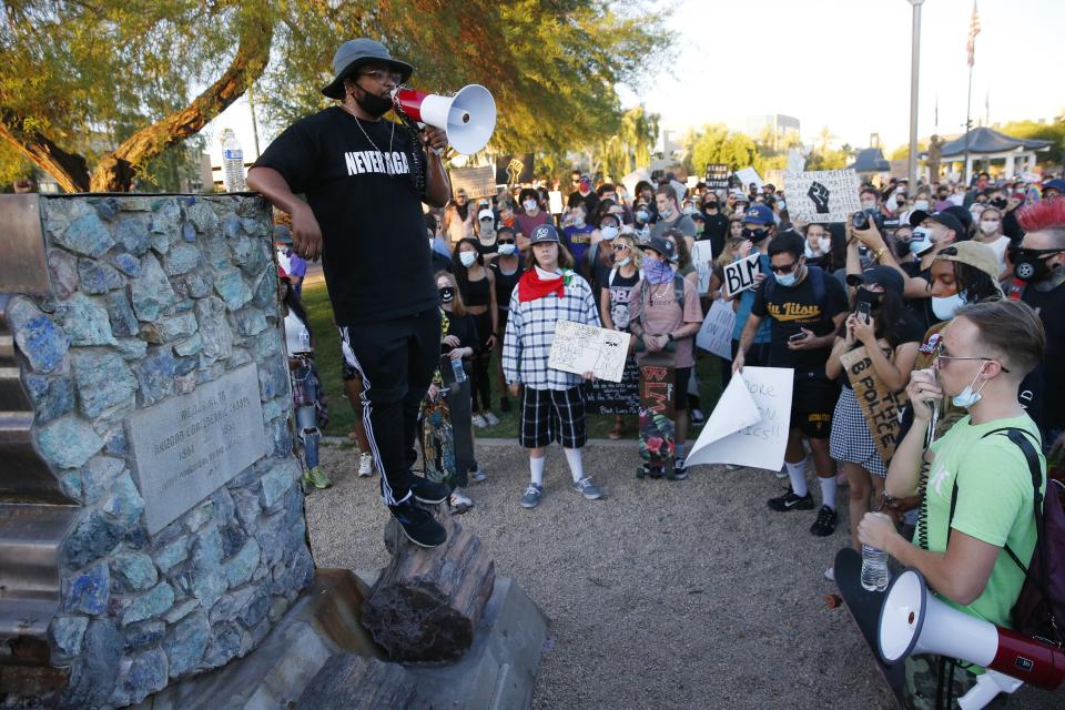 Jacob Raiford rallies protesters around a Confederate monument at the state Capitol during a march against racial injustice in Phoenix on June 9, 2020.