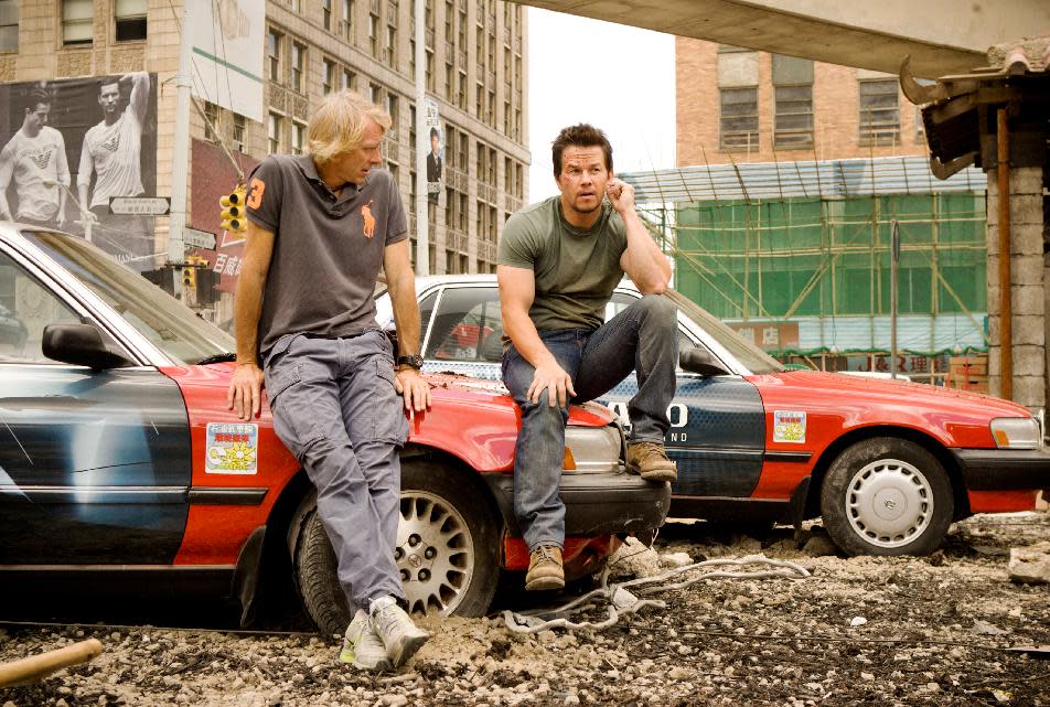 This image released by Paramount Pictures shows director Michael Bay, left, with Mark Wahlberg on the set of "Transformers: Age of Extinction." (AP Photo/Paramount Pictures, Andrew Cooper)