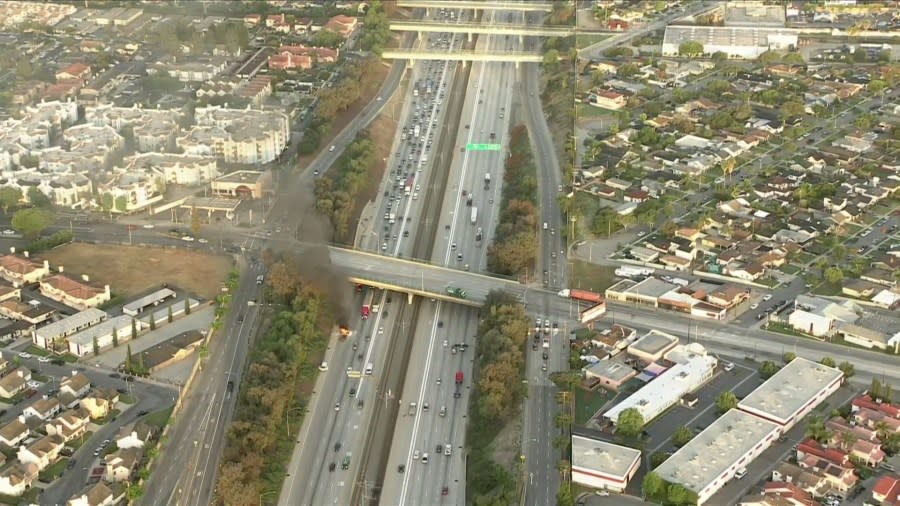 A burning van on the 105 Freeway in the City of Paramount caused delays for commuters early Monday morning. (Sky5)