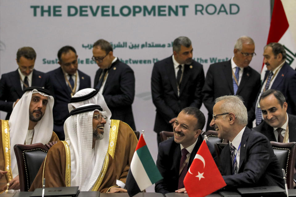 UAE's Energy Minister Suhail Mohamed al-Mazrouei, left, and Turkey's Transport Minister Abdulkadir Uraloglu, right, speak together during the signing of the "Development Road" framework agreement on security, economy, and development in Baghdad, Iraq, Monday April 22, 2024. (Ahmad Al-Rubaye/Pool via AP)