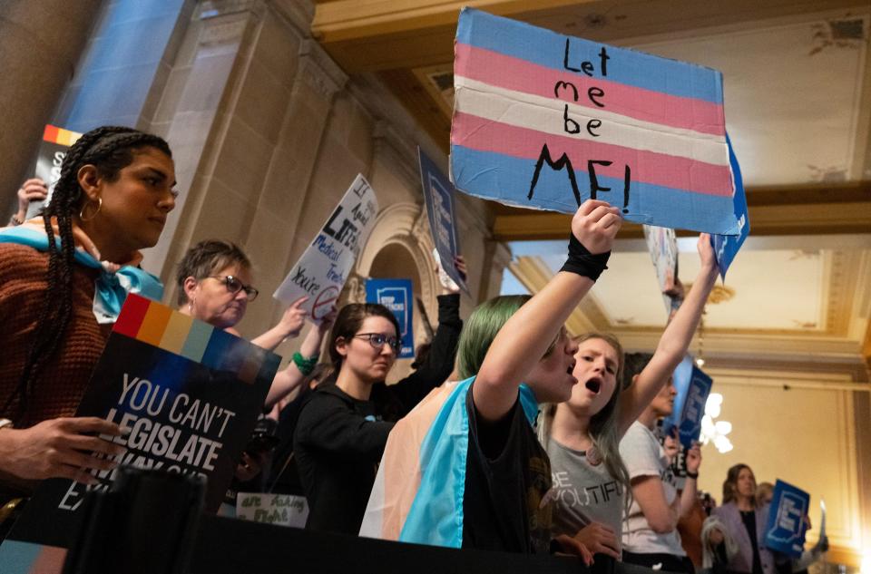 People protest against SB 480, a total ban on affirming care for transgender youth, while the Indiana House public health committee has a hearing Tuesday, March 21, 2023, in the House Chamber of the Indiana State Capitol building.